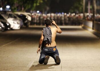 A demonstrator kneels