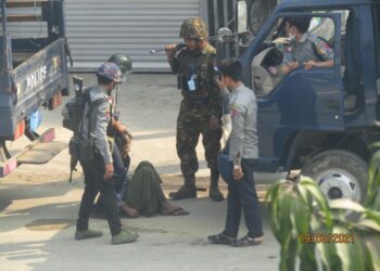 Terrorists strangling a civilian’s neck with a rope