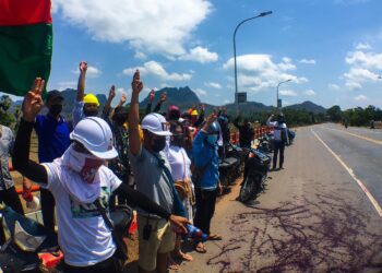 Activists splash red paint to protest military bloodshed